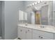 Double vanity bathroom with large mirror at 1858 Norvell Ave, North Port, FL 34286