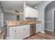 White kitchen cabinets and stainless steel dishwasher at 1858 Norvell Ave, North Port, FL 34286