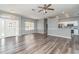Open concept living room and kitchen with wood-look floors at 1858 Norvell Ave, North Port, FL 34286
