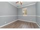 Spacious bedroom with wood-look floors and ceiling fan at 1858 Norvell Ave, North Port, FL 34286
