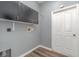 Laundry room with upper cabinets and vinyl flooring at 1858 Norvell Ave, North Port, FL 34286
