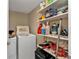 Laundry room with washer, dryer, and ample storage shelves at 101 N Marion Ct # 122, Punta Gorda, FL 33950