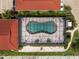 Aerial view of a covered pool featuring lounge chairs and landscaping at 1 Colony Point Dr # 16B, Punta Gorda, FL 33950