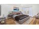 Bedroom features hardwood floors, a large bed, and an abstract painting on the wall at 1 Colony Point Dr # 16B, Punta Gorda, FL 33950