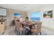 Dining room boasts water views, a modern light fixture, and seating for six at 1 Colony Point Dr # 16B, Punta Gorda, FL 33950