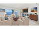 Bright living room features ample seating, TV, and stunning water views through large windows at 1 Colony Point Dr # 16B, Punta Gorda, FL 33950