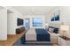 This bedroom features a modern bed, ocean view, and hardwood floors at 1 Colony Point Dr # 16B, Punta Gorda, FL 33950