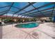 The covered pool area features ample lounge chairs and a peaceful view of the property at 1 Colony Point Dr # 16B, Punta Gorda, FL 33950