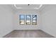 Well-lit bedroom with three large windows and grey flooring at 17315 Cape Horn Blvd, Punta Gorda, FL 33955