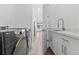 Modern laundry room with a utility sink and white cabinets at 17315 Cape Horn Blvd, Punta Gorda, FL 33955