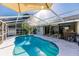 Large screened pool with outdoor bar in the background at 18370 Inwood Ave, Port Charlotte, FL 33948