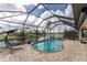 Relaxing pool area with a screened enclosure and lake view at 24211 Savory Ln, Punta Gorda, FL 33955