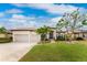 Beautiful two-car garage home with landscaping and a paved driveway at 24211 Savory Ln, Punta Gorda, FL 33955
