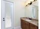Bathroom with granite countertop, single sink, and exterior access at 24211 Savory Ln, Punta Gorda, FL 33955