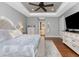 Main bedroom with large bed, hardwood floors, and access to bathroom at 24211 Savory Ln, Punta Gorda, FL 33955
