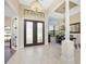 Elegant entryway with double doors, high ceilings, and chandelier at 24211 Savory Ln, Punta Gorda, FL 33955