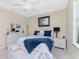 Bright bedroom with a queen-size bed and a built-in bench at 24211 Savory Ln, Punta Gorda, FL 33955