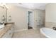 Spa-like bathroom with granite countertops and a large soaking tub at 24211 Savory Ln, Punta Gorda, FL 33955