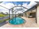 Stunning kidney shaped pool with screened enclosure and backyard access at 24211 Savory Ln, Punta Gorda, FL 33955