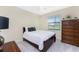 Cozy bedroom with a full-size bed and a large dresser at 24211 Savory Ln, Punta Gorda, FL 33955