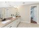 Double vanity bathroom with granite countertops and a view of the bedroom at 24211 Savory Ln, Punta Gorda, FL 33955