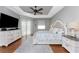 Spacious main bedroom with hardwood floors and large TV at 24211 Savory Ln, Punta Gorda, FL 33955