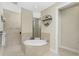 Elegant bathroom with soaking tub, walk-in shower, and double vanity at 24211 Savory Ln, Punta Gorda, FL 33955