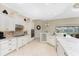 Gourmet kitchen with double ovens, custom cabinetry, and breakfast bar at 24211 Savory Ln, Punta Gorda, FL 33955