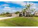 One-story house with two-car garage and lush landscaping at 24211 Savory Ln, Punta Gorda, FL 33955