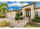 Exterior view of a two-story home with a three-car garage and landscaped walkway at 24211 Savory Ln, Punta Gorda, FL 33955