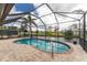 Relaxing kidney-shaped pool with screened enclosure overlooking canal at 24211 Savory Ln, Punta Gorda, FL 33955