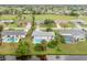 Bright aerial view of a charming single-Gathering home featuring a private backyard pool and lush landscaping at 25 Caddy Rd, Rotonda West, FL 33947