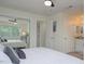 Bright bedroom featuring a closet with mirrored doors, ceiling fan, and ensuite bathroom at 25 Caddy Rd, Rotonda West, FL 33947