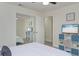 Well-lit bedroom featuring a closet with mirrored doors, a ceiling fan, and a modern TV at 25 Caddy Rd, Rotonda West, FL 33947