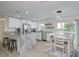Bright, modern kitchen with white cabinets, stainless appliances, and an island with granite countertops at 25 Caddy Rd, Rotonda West, FL 33947