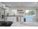Open kitchen with stainless steel appliances, white cabinets, granite counters and backyard views at 25 Caddy Rd, Rotonda West, FL 33947