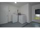 Laundry room with side-by-side washer and dryer, hot water heater, and exterior door at 25 Caddy Rd, Rotonda West, FL 33947