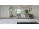Open concept living area with a gray couch, bay window, wood floors and stylish decor at 25 Caddy Rd, Rotonda West, FL 33947
