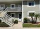 Two-story building with white railings and landscaping at 3310 Loveland Blvd # 604, Port Charlotte, FL 33980