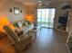 Living room with lake view and comfy seating at 3310 Loveland Blvd # 604, Port Charlotte, FL 33980