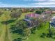 A two-story house with a screened-in pool and lush landscaping, seen from above at 17253 Naiad Ct, Punta Gorda, FL 33955