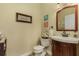 Charming powder room with wooden vanity and mirror at 17253 Naiad Ct, Punta Gorda, FL 33955