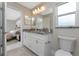 Bathroom with double vanity, granite countertop and view of bedroom at 8749 Tweed Ter, North Port, FL 34288