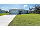 Newly built home with a light blue exterior and a large yard at 8749 Tweed Ter, North Port, FL 34288