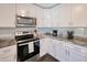 Modern kitchen with white cabinets and stainless steel appliances at 3173 S Cranberry Blvd, North Port, FL 34286