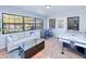 Fun game room with air hockey table, seating area, and large windows at 3173 S Cranberry Blvd, North Port, FL 34286