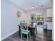 Bright dining room with a wooden table and teal chairs, leading to a sunroom at 3173 S Cranberry Blvd, North Port, FL 34286