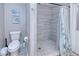 Bathroom with walk-in shower, toilet and grey tile floor at 3173 S Cranberry Blvd, North Port, FL 34286