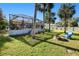 Spacious backyard with a screened pool, palm trees, and fire pit at 3173 S Cranberry Blvd, North Port, FL 34286