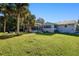 Large backyard with a pool and a view of the home's exterior at 3173 S Cranberry Blvd, North Port, FL 34286
